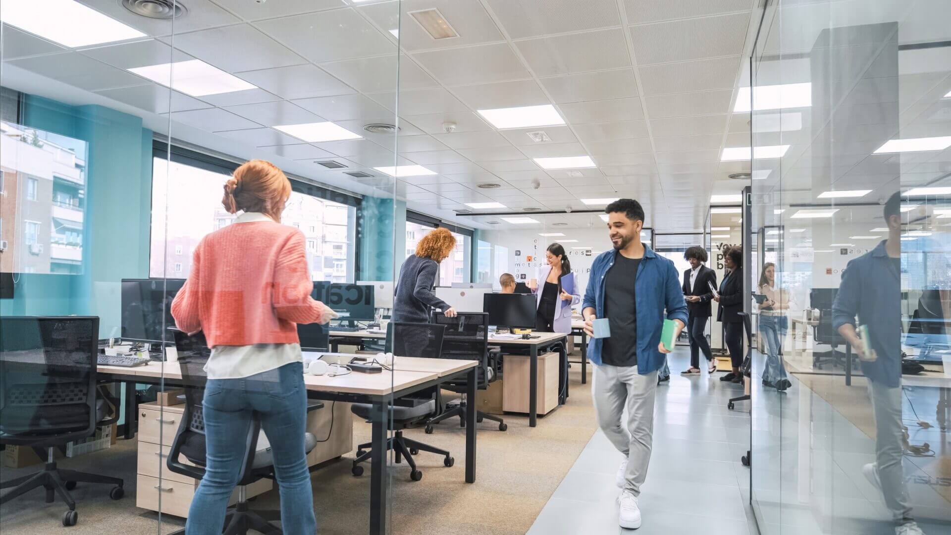 Busy office with people working and walking.