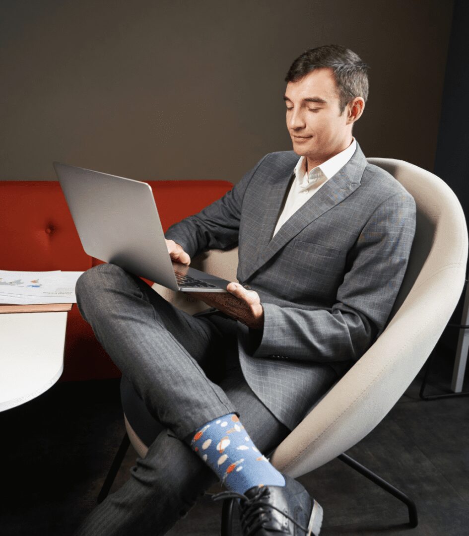 Man in suit working on a laptop.